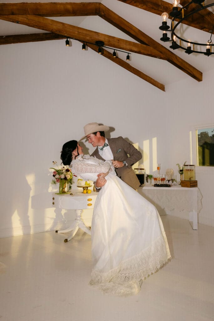 Western Bride and groom dancing at a Florida wedding venue photographed by Through Her Lens Photography