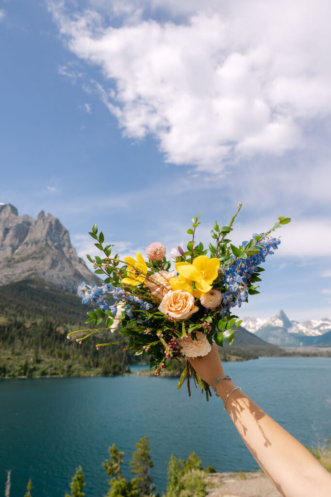 Bridal bouquet overlooking Glacier National Park during their early July elopement.
