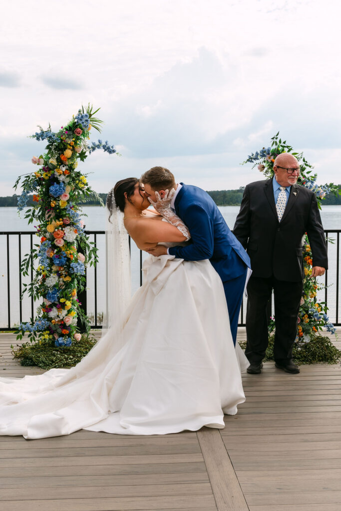 true to color wedding ceremony first kiss documented by a lake in Alabama